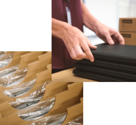 a pair of hands handling stacked laptop computers